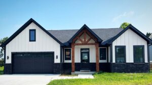 One story home of vinyl and stone with wooden transom